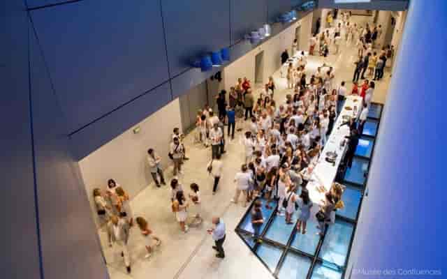 Espaces liants at Musée des Confluences: vibrant registration area for networking event.
