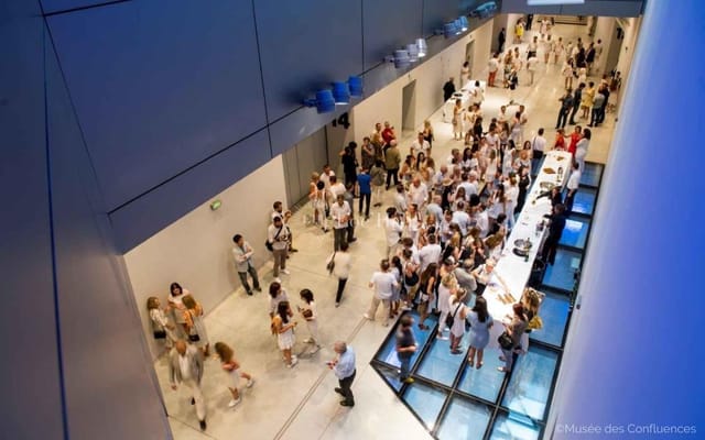 Espaces liants at Musée des Confluences: vibrant registration area for networking event.