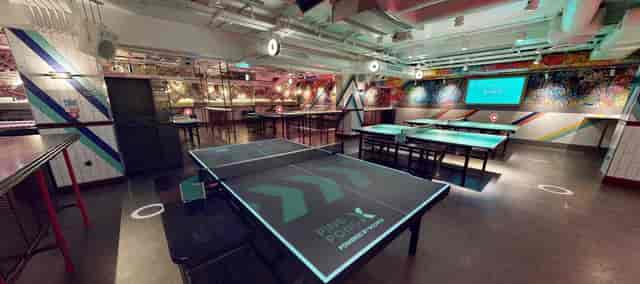 Vibrant event space with ping pong tables for team-building and social gatherings.