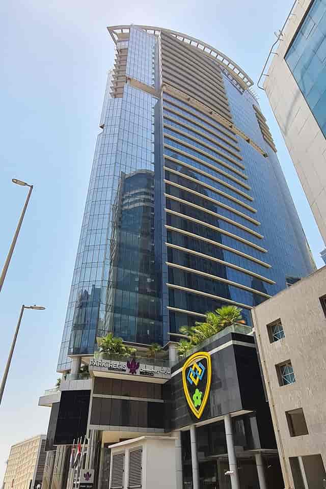 Modern high-rise Manzil at Park Regis, ideal for corporate events with sleek glass façade.