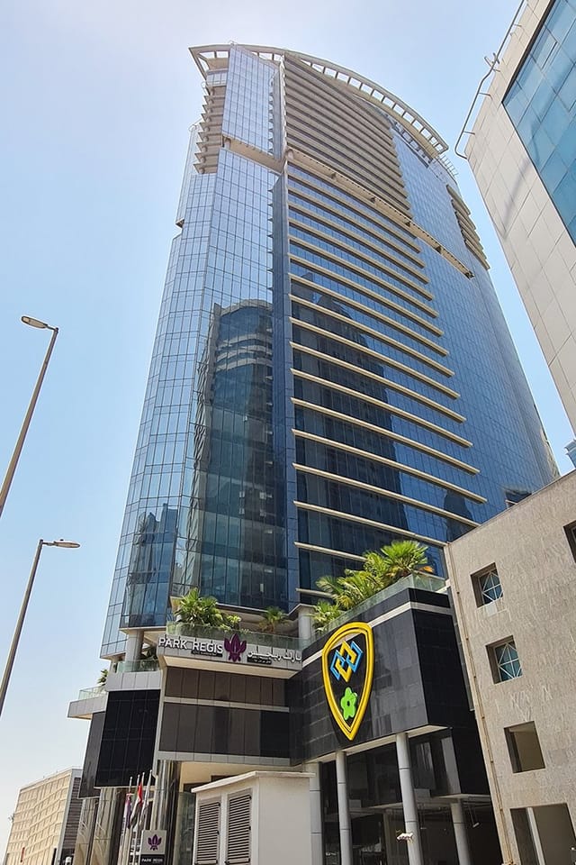 Modern high-rise Manzil at Park Regis, ideal for corporate events with sleek glass façade.