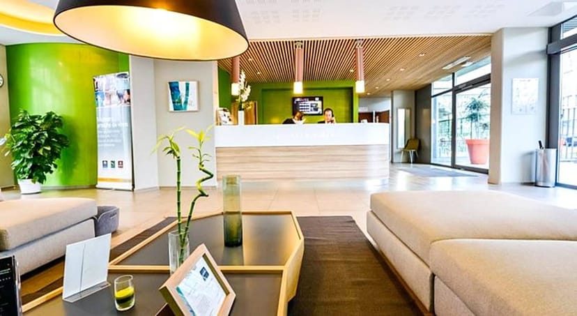 Modern VIP Lounge at Q7 Lodge with vibrant green accents, ideal for meetings and events.