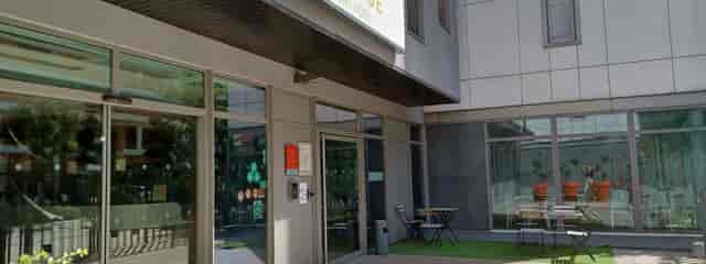 Modern Q7 Lodge Main Hall entrance with glass facade, perfect for events and meetings.