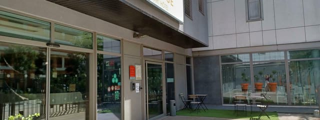 Modern Q7 Lodge Main Hall entrance with glass facade, perfect for events and meetings.