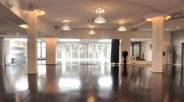Elegant event venue with polished wood floors, ideal for corporate meetings and social gatherings.