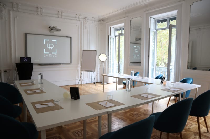 Sleek meeting room with large windows, ideal for corporate events and workshops.