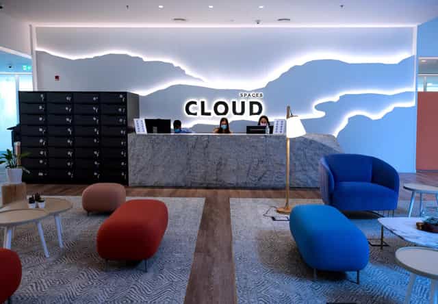 Modern meeting room reception with illuminated "CLOUD" sign for networking events.