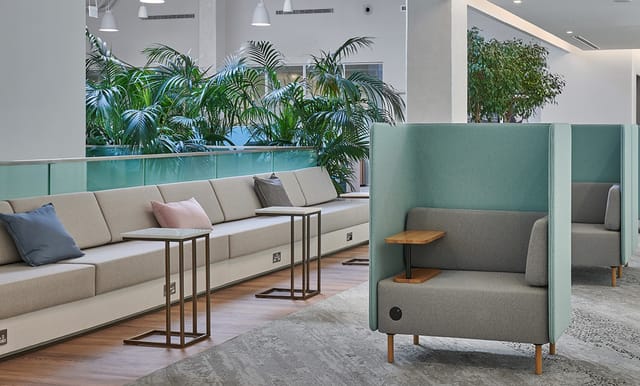 Modern co-working lounge with comfortable seating for informal meetings and networking.