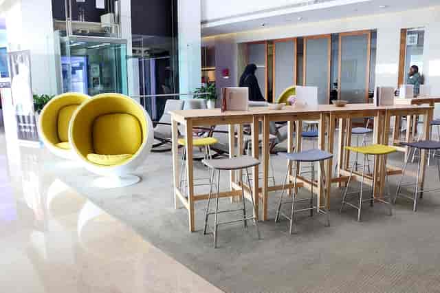 Modern meeting space in HUES Boutique Hotel with vibrant yellow accents for networking events.