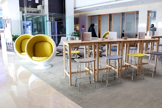 Modern meeting space in HUES Boutique Hotel with vibrant yellow accents for networking events.