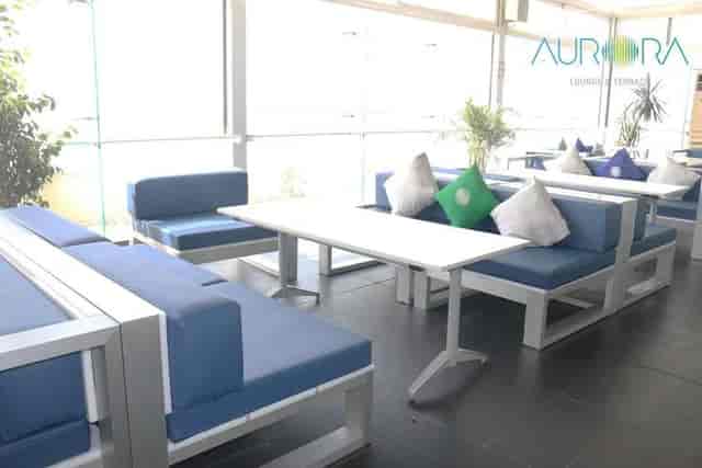 Modern lounge with blue seating and natural light, perfect for meetings and events.