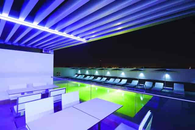 Aurora Lounge rooftop venue with modern seating and pool, perfect for evening events.
