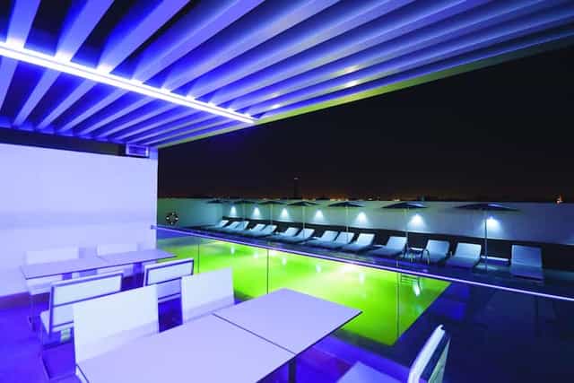 Aurora Lounge rooftop venue with modern seating and pool, perfect for evening events.
