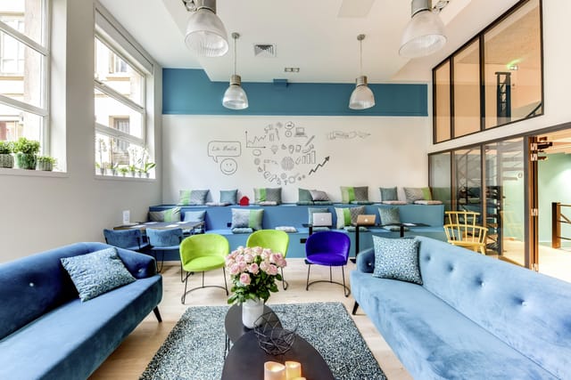 Modern meeting space with cozy blue sofas for collaborative networking events.