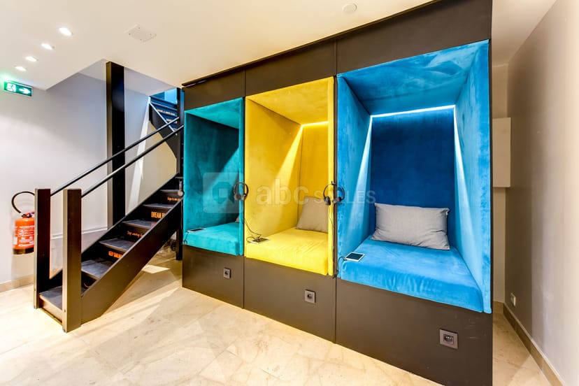 Modern function room with soundproof booths for creative meetings, ideal for events.