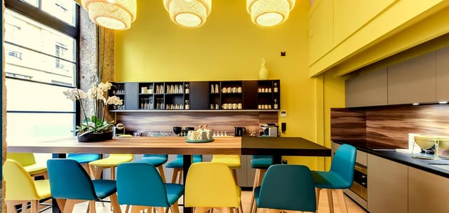 Vibrant meeting room with yellow walls, large table, ideal for brainstorming events.