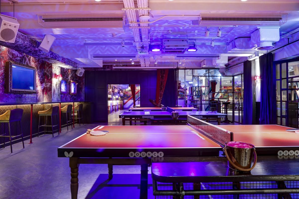 Vibrant event space with ping pong tables for social gatherings in Shoreditch. - Banner