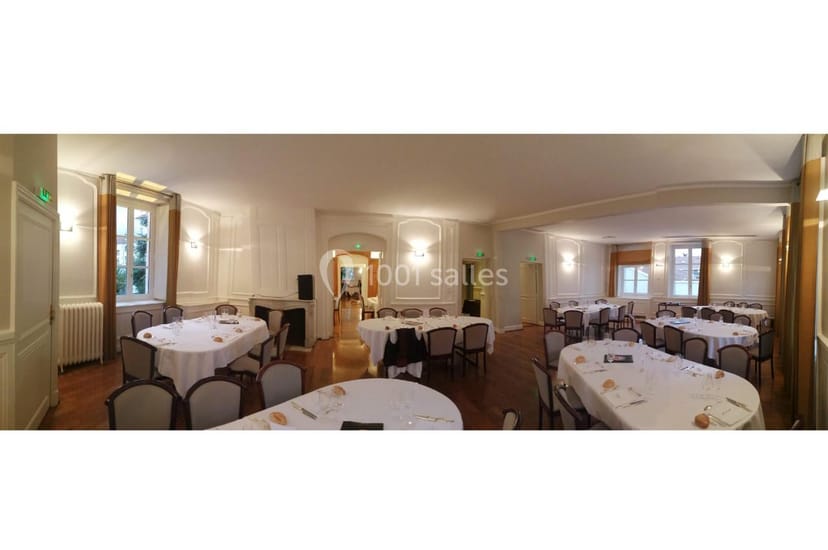 Well-lit event space with round tables at Château de Montchat for intimate gatherings.