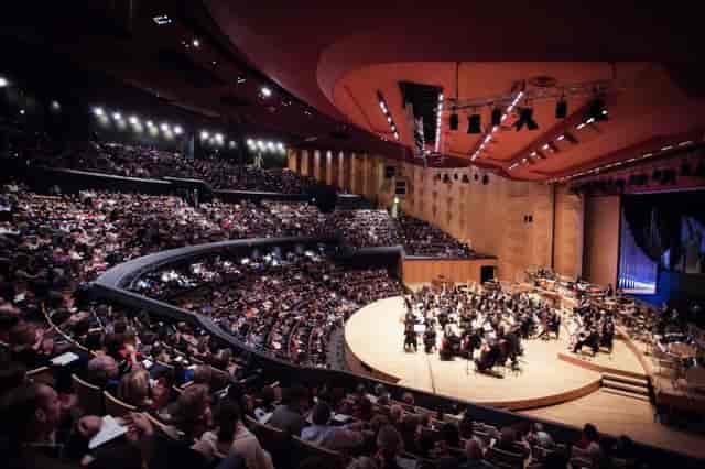 Packed Lyon auditorium during an orchestra performance - ideal for events and showcases.