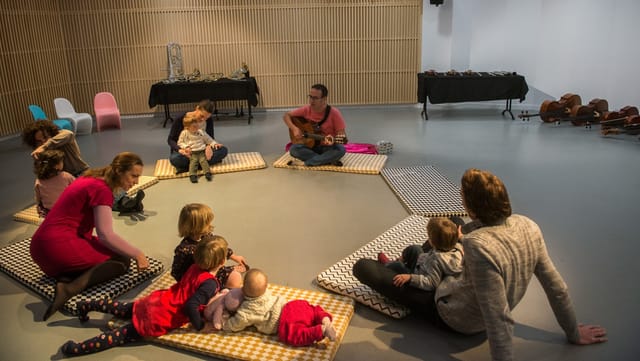 Cozy interactive space at Auditorium de Lyon for family music events with children.