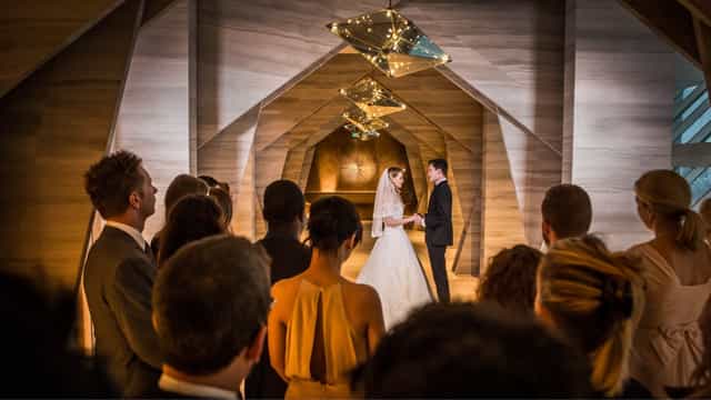 "Elegant wedding ceremony at Vista Ballroom, FIVE Palm Jumeirah, Dubai with warm lighting."
