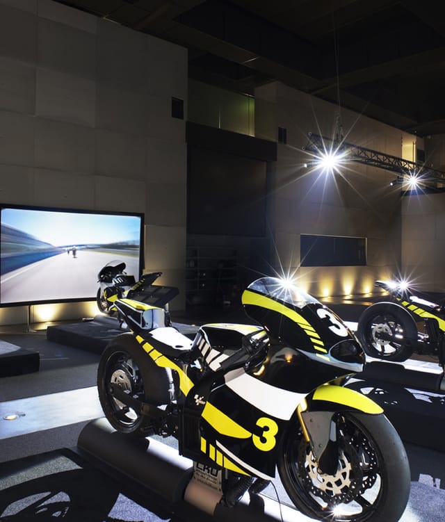 "High-tech racing motorcycles at Simulation Moto GP event for immersive brand engagement."