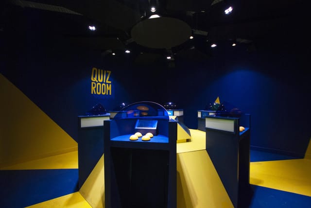 Modern blue and yellow quiz room for interactive team-building events.