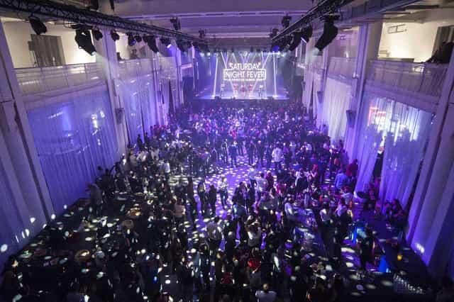 La Sucrière event space in Lyon with dramatic lighting and lively atmosphere.