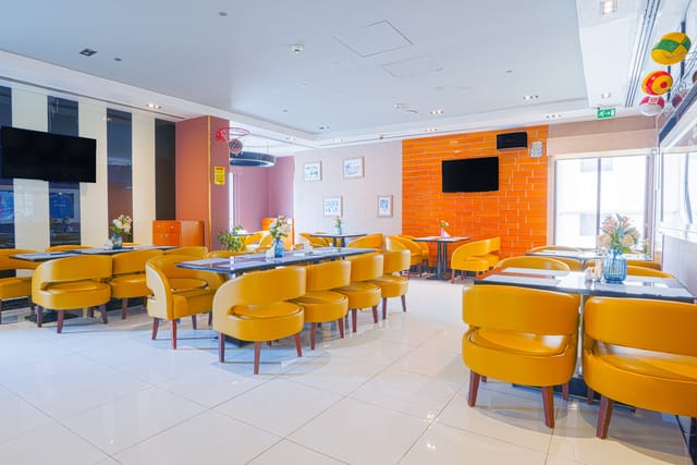 Modern dining space in Reflections Hotel with bright chairs, ideal for events and meetings.
