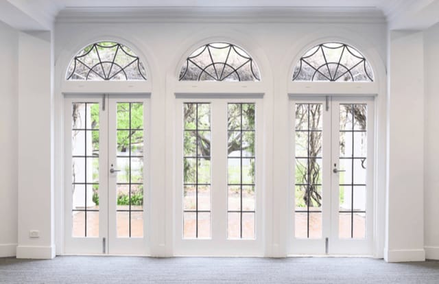 Elegant doors framed by large windows at Ian Potter House Ballroom for events.