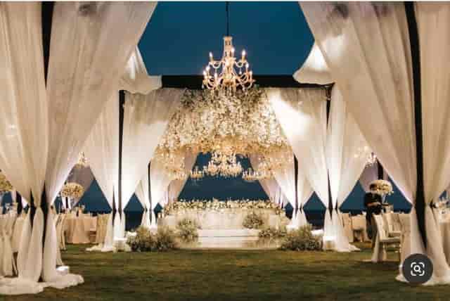Elegant outdoor wedding reception setup in Dubai with white draping and floral decor.