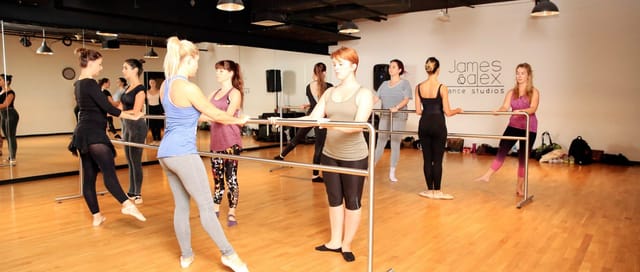 Group of dancers practicing ballet in a bright dance studio, perfect for workshops and classes.