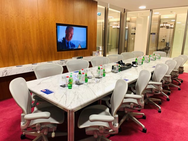 Modern meeting room with marble table, ideal for corporate events and presentations.