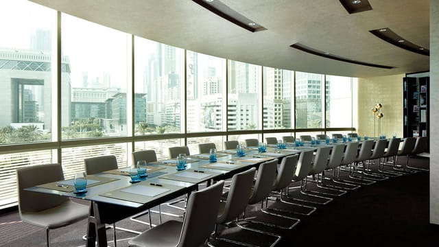 Modern boardroom in Jumeirah Emirates Towers with city view, perfect for corporate meetings.