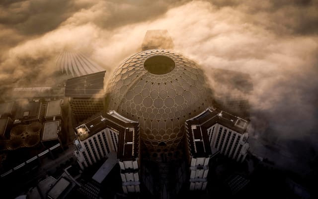 Aerial view of Al Wasl Plaza dome in fog, ideal for unique conferences and events.