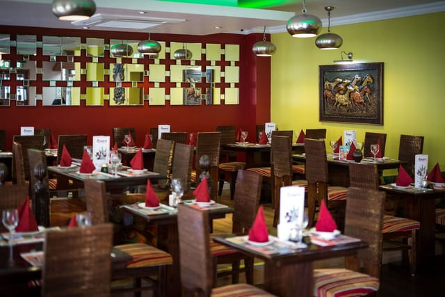 Vibrant dining space with red napkins, perfect for events or business meetings at Arnero.