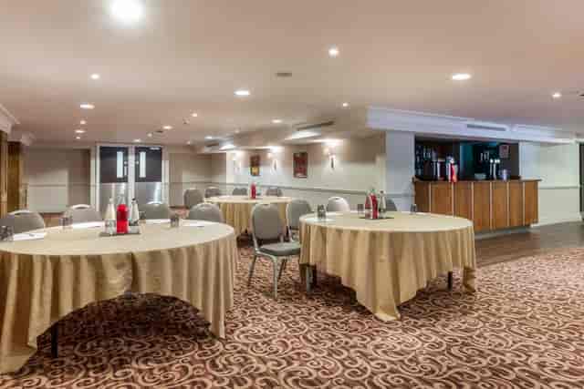 Tatton Suite at Pinewood Hotel, inviting meeting space for events with round tables.