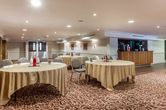 Tatton Suite at Pinewood Hotel, inviting meeting space for events with round tables.