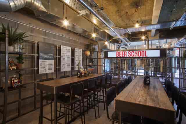Alt text: Trendy BrewDog Manchester beer garden with communal tables for events and gatherings.