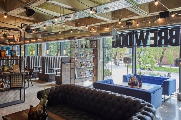 Modern beer garden at BrewDog Manchester with stylish decor, perfect for events.