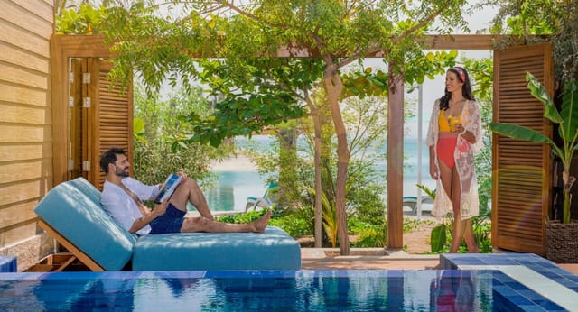Serene outdoor meeting space at Meliá Desert Palm with lush greenery and tranquil pool.