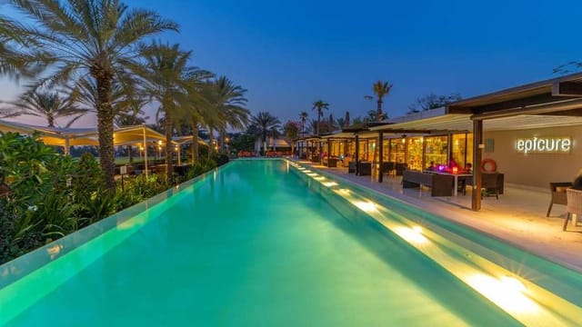 Chic outdoor venue at Meliá Desert Palm with sleek pool for networking events and receptions.