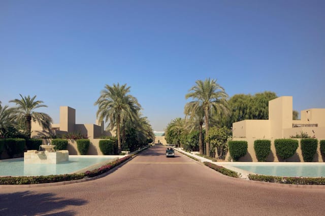 Elegant venue entrance at Chukka, surrounded by water features and palm trees for events.