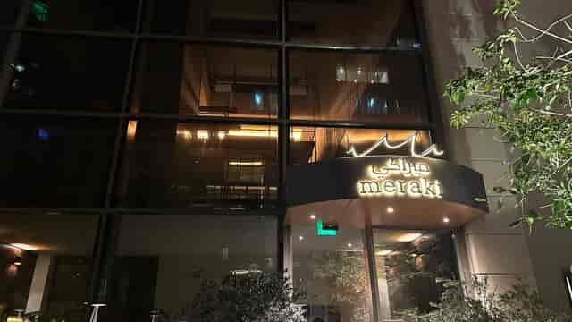 Stylish Meraki Restaurant entrance with illuminated signage for upscale events.