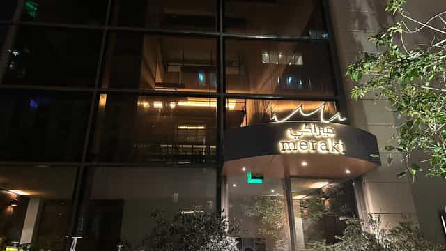 Stylish Meraki Restaurant entrance with illuminated signage for upscale events.