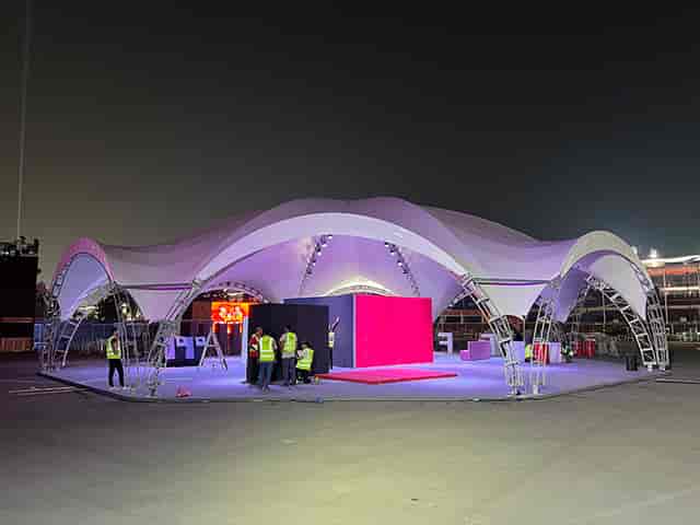 Modern ARCH OCTA tent with undulating canopy, ideal for outdoor events and gatherings.