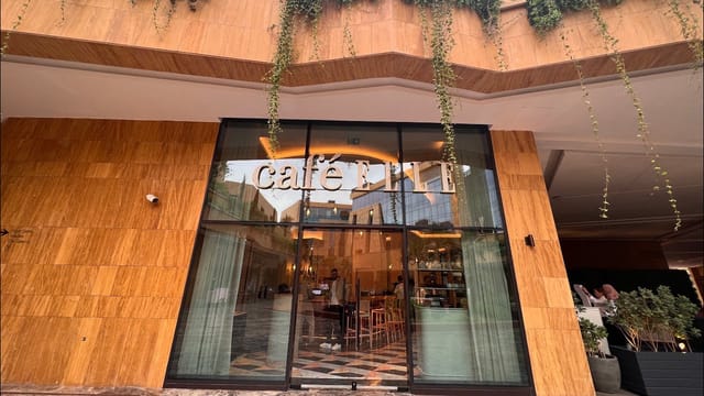 Stylish glass entrance of Café ELLE, perfect for networking and casual meetings in VIA Riyadh