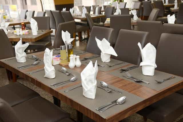 Elegant dining table setup at Rehab Al Nour Hotel for formal business events.