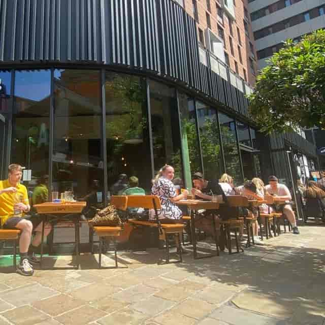 Outdoor dining at Nell's Kampus bar, perfect for casual networking and social gatherings.