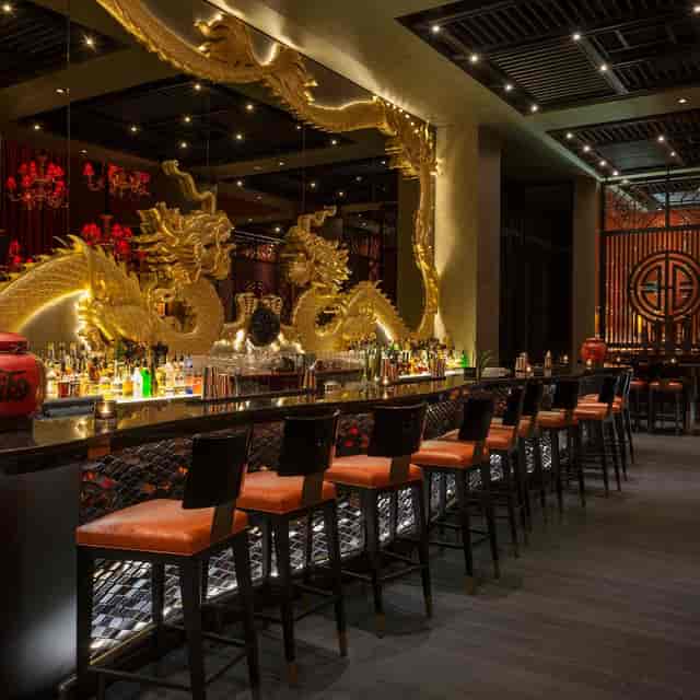Main Dining Area at Buddha-Bar Dubai with dragon sculptures, elegant for cocktail events.